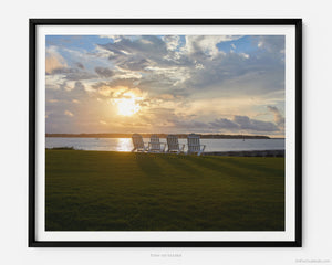 Located within Hilton Head Island’s Sea Pines Plantation, this peaceful sunset scene features four Adirondack chairs overlooking the tranquil waterways of the Calibogue Sound with Daufuskie Island in the distance.