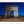 Load image into Gallery viewer, This Paris photography print is a timeless summer night scene of the Arc de Triomphe in Paris, France. This long exposure photo, shows cars swirling around the centre of Place Charles de Gaulle, standing at the western end of the Champs-Élysées. The summer night lends itself to showcase this Neoclassical monument against the crystal blue night sky.