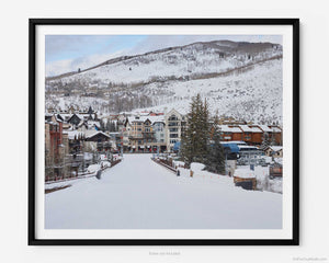 This fine art photography print is of Vail Ski Resort in Vail, Colorado. This image captures the majestic beauty of Lionshead Village during the winter ski season, showcasing the town's picturesque charm and natural splendor.