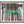 Load image into Gallery viewer, This fine art photography print shows winter in Vail, Colorado at Vail Ski Resort. A directional sign is found erected and reads “Cub’s Way” as a guide for the beginner (green – and easiest) ski trail, with the skinny trunks of pine trees in the background.