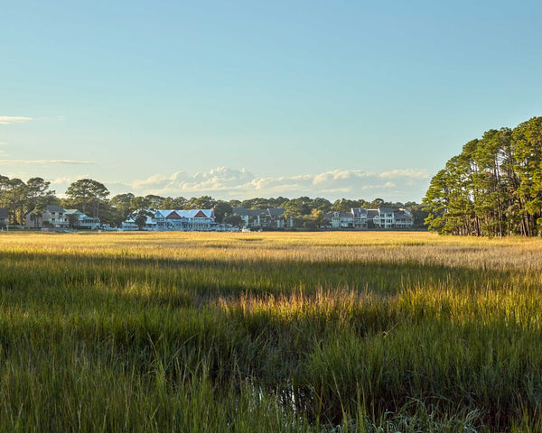 A picture looking Over Marsh Towards Salty Dog Cafe And South Beach Marina, Hilton Head Island Fine Art Photography Print. Perfect for wall art.