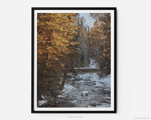 This fine art photography print shows winter in Vail, Colorado at Vail Ski Resort. As the sunsets, a rustic wood bridge spans across the peaceful waterways of Gore Creek. 