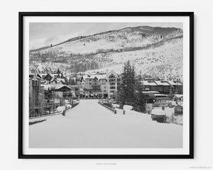 This black and white fine art photography print is of Vail Ski Resort in Vail, Colorado. This image captures the majestic beauty of Lionshead Village during the winter ski season, showcasing the town's picturesque charm and natural splendor. 