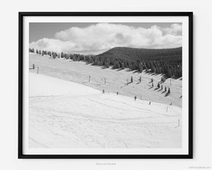 This black and white fine art photography print shows winter in Vail, Colorado at Vail Ski Resort. This view of the Back Bowls from Two Elk Lodge includes black and blue ski runs and the Orient Express Ski Lift in the distance.