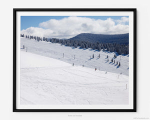 This fine art photography print shows winter in Vail, Colorado at Vail Ski Resort. This view of the Back Bowls from Two Elk Lodge includes black and blue ski runs and the Orient Express Ski Lift in the distance.