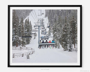 This fine art photography print shows the iconic Avanti Express ski lift at Vail Ski Resort in Vail, Colorado. The piece captures the excitement of skiers as they make their way up the mountain.
