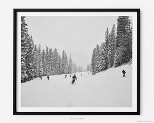 This black and white fine art photography print shows winter in Vail, Colorado at Vail Ski Resort. Capturing the thrill of skiing down the Flapjack run, this print showcases fresh powder, snow dusted pine trees, and the winding trail that weaves its way through the trees.