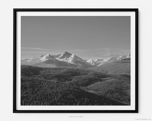 This black and white fine art photography print shows winter at Vail Ski Resort in Colorado's Rocky Mountains. At Vail Ski Resort, just a few steps away from the Eagle Bahn Gondola is an overlook. In the distance, the summit of the Mount of the Holy Cross is covered in snow. 