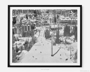 This black and white fine art photography print shows winter in Vail, Colorado at Vail Ski Resort. Skiers and snowboarders descend down the Eagle Bahn Gondola, taking in the relaxing views of Lionshead Village and Vail Square. 