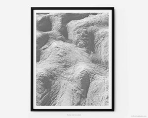 This black and white fine art photography print transports you to winter at Vail Ski Resort in Colorado. As you look down off of the Wildwood Express ski lift, you take in a captivating overhead view of moguls etched in snow on a black diamond ski run by skiers and snowboarders.