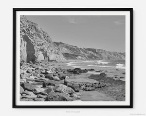 This fine art photography print shows the natural rock formations facing the Pacific Ocean from Black's Beach at Torrey Pines National Reserve in San Diego, California. Miles of pristine beach stretch out into the distance. 